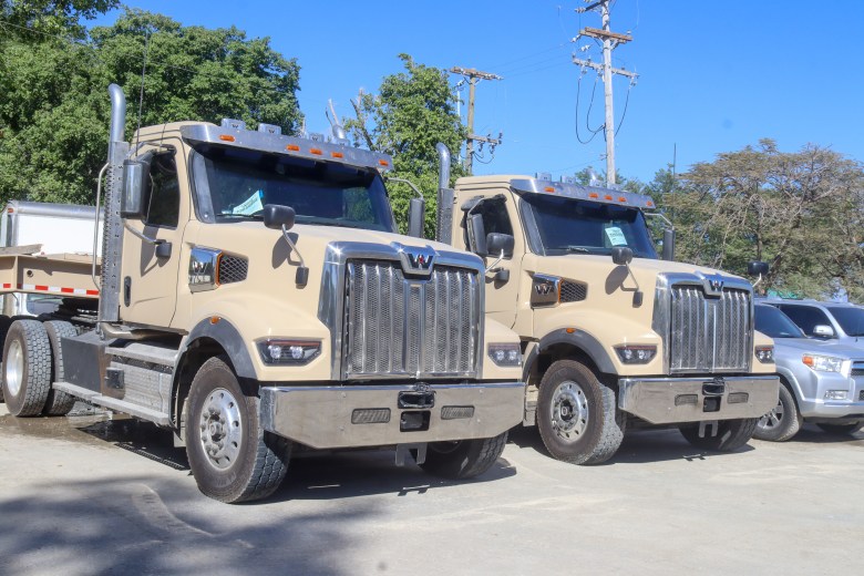 Two trucks donated by the U.S. to the Haitian National Police to support their fight against gangs in Port-au-Prince on Monday, Feb. 10 2025. Photo by Dieugo André for The Haitian Times.